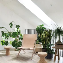 Teise korruse valgusküllane trepihall on sobiv paik toataimedele. Nahast istmega klapptool pärineb Taani ettevõttelt By Lassen.